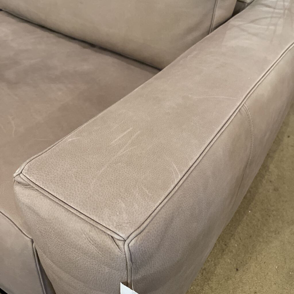 Close-up of a beige leather sofa corner