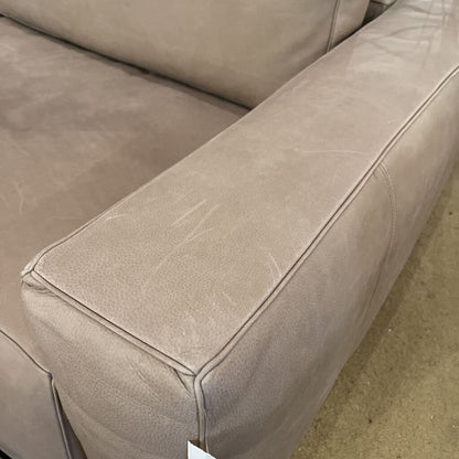 Close-up of a beige leather sofa corner