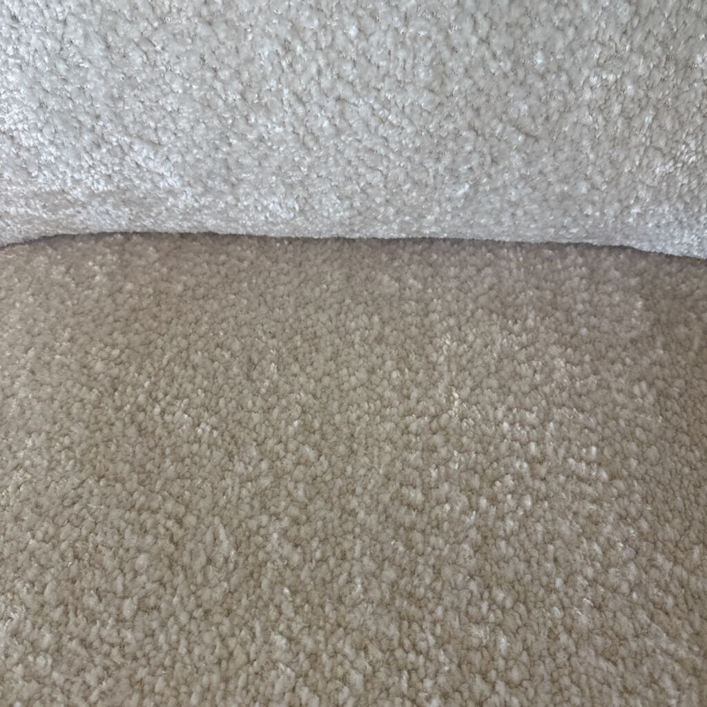 Close-up of two different carpet textures, one light gray and one beige.