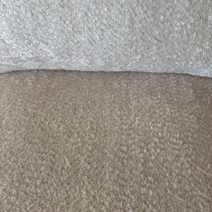 Close-up of two different carpet textures, one light gray and one beige.