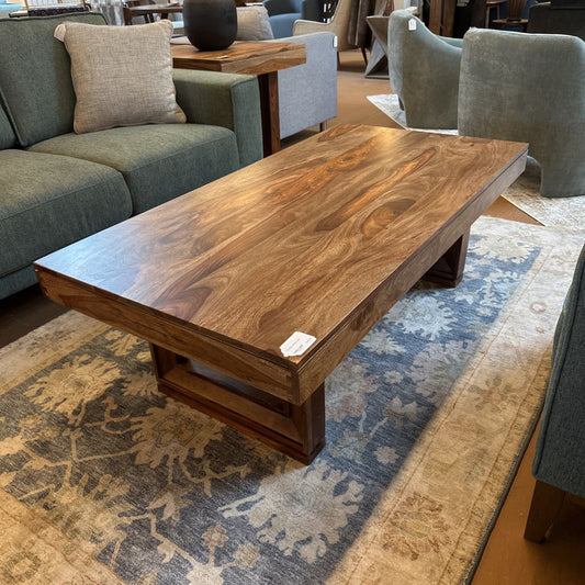 Wooden coffee table in a room with furniture and decor