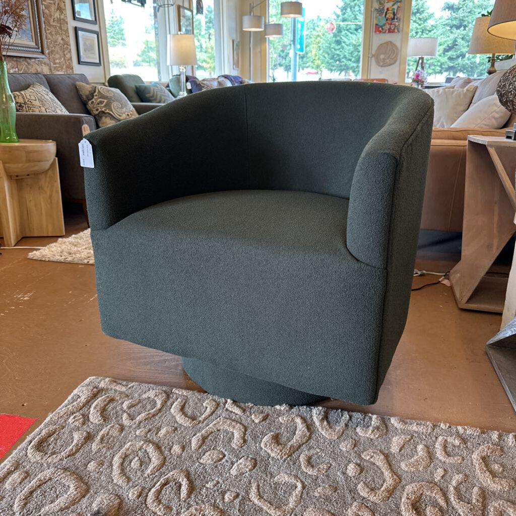 Gray armchair in a showroom with furniture and decor around