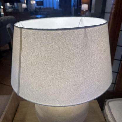 Textured lampshade on a lamp in an indoor setting