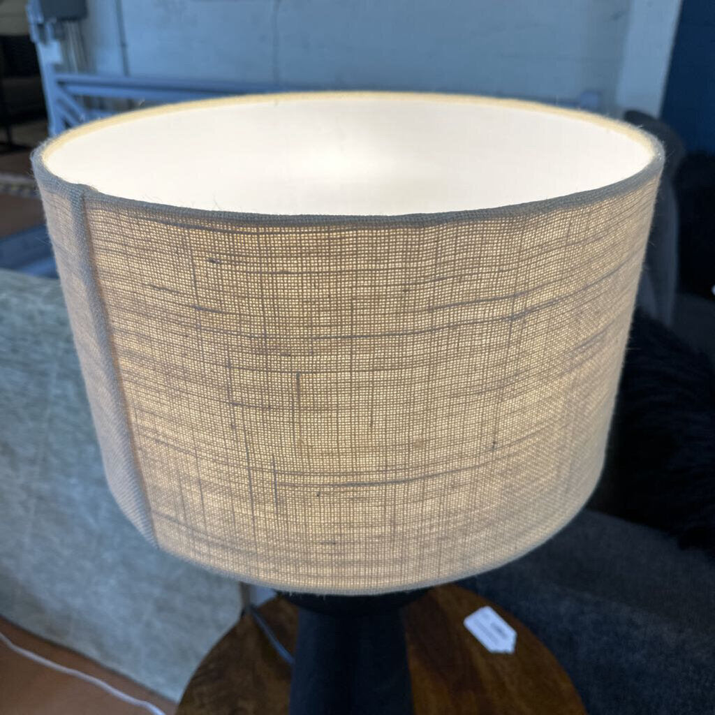 Textured lampshade on a lamp in an indoor setting