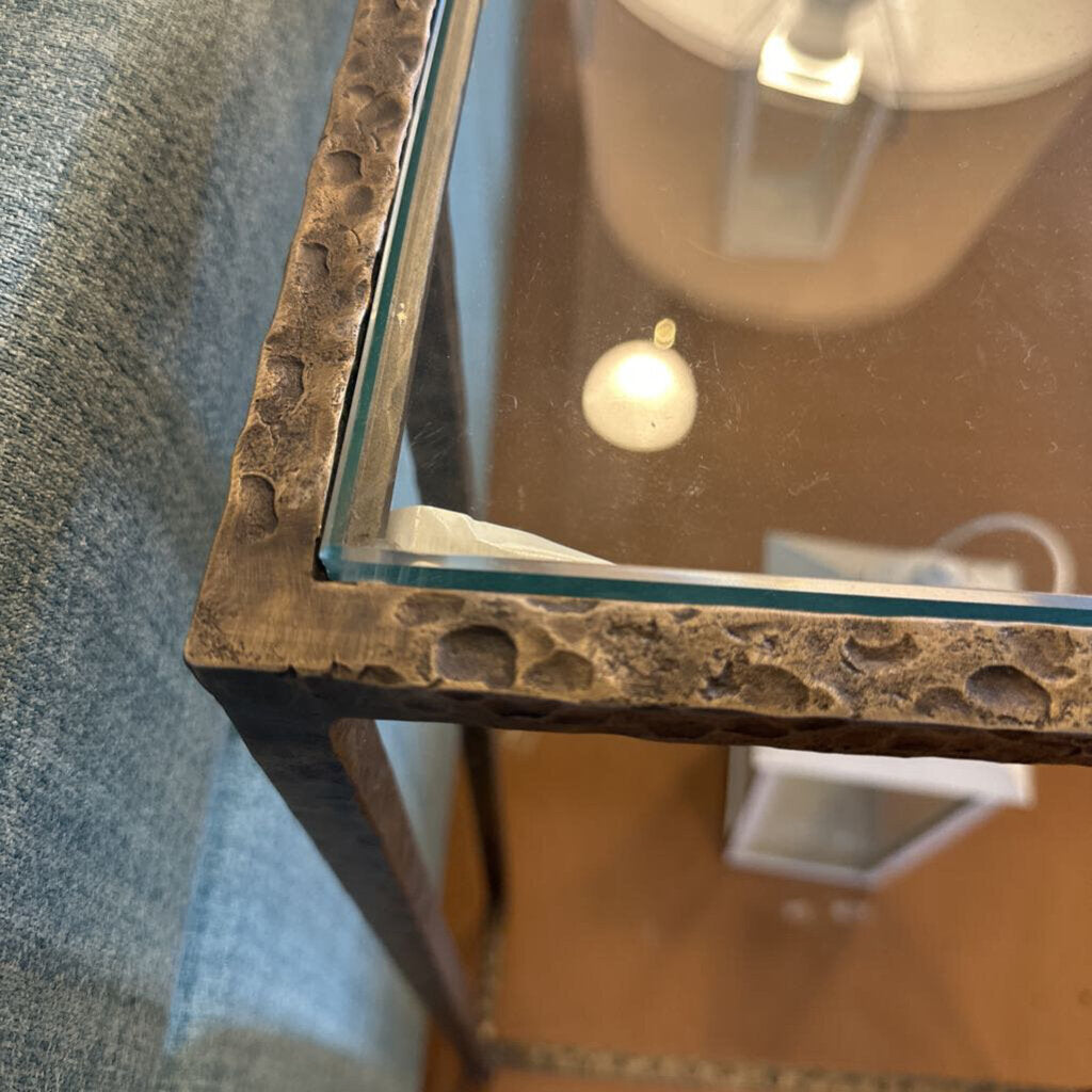 Close-up of a textured mirror frame with a blurred background