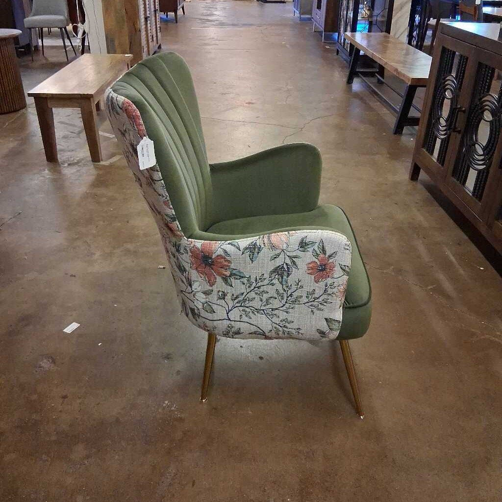 Chair with floral pattern and green backrest on a concrete floor