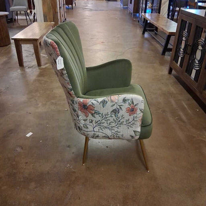 Chair with floral pattern and green backrest on a concrete floor