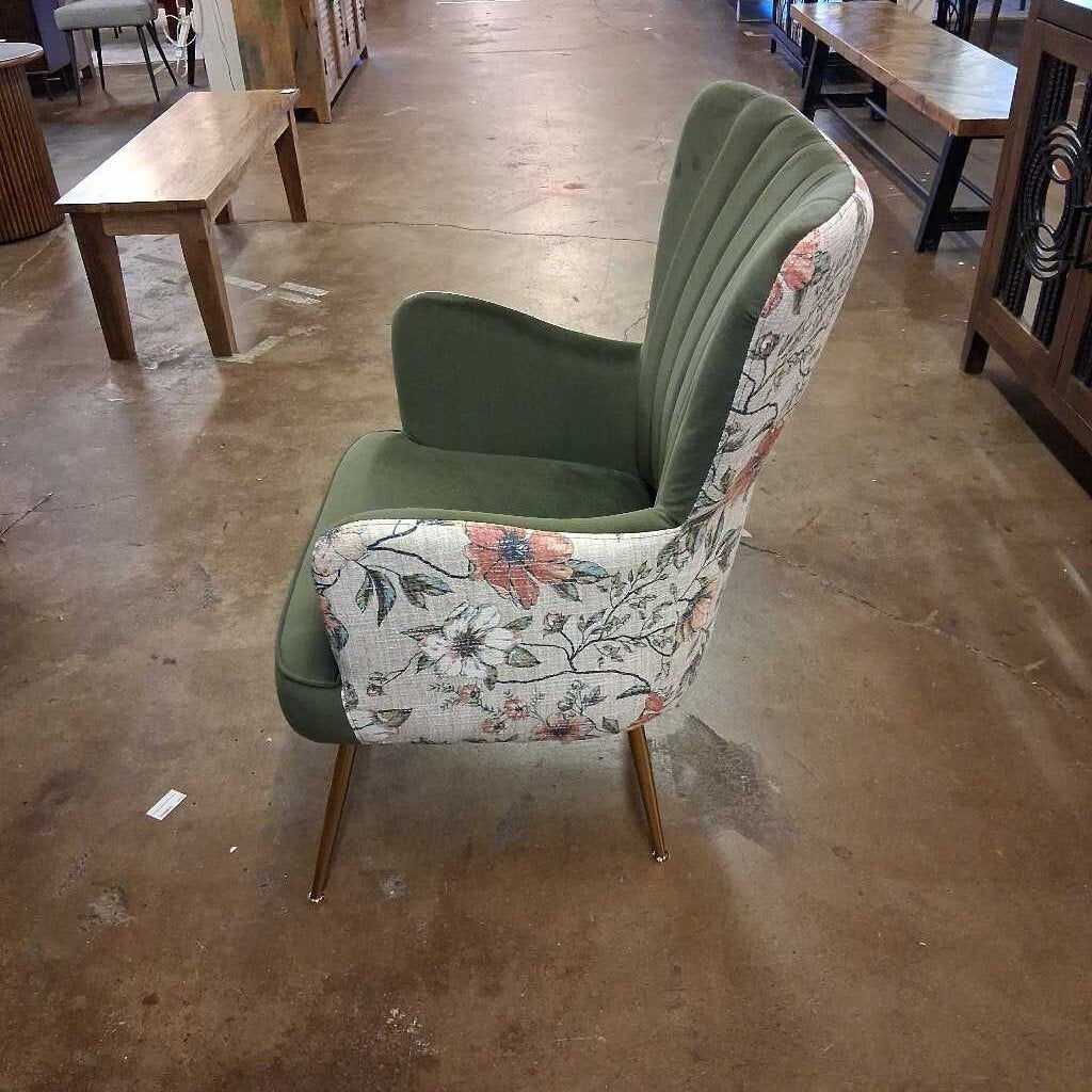 Chair with floral backrest and green seat in a warehouse setting