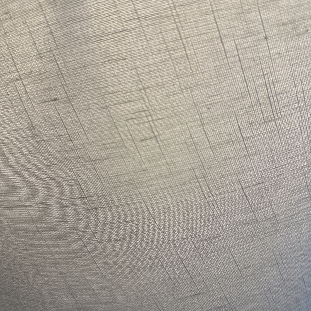 Close-up of gray textured fabric with a subtle pattern