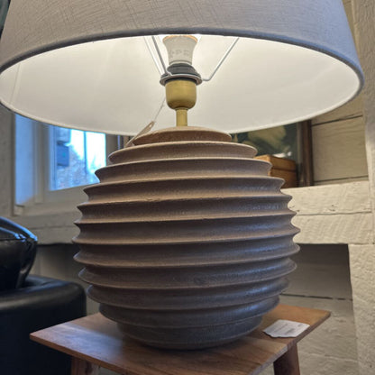 Decorative lamp with ribbed design on a wooden table