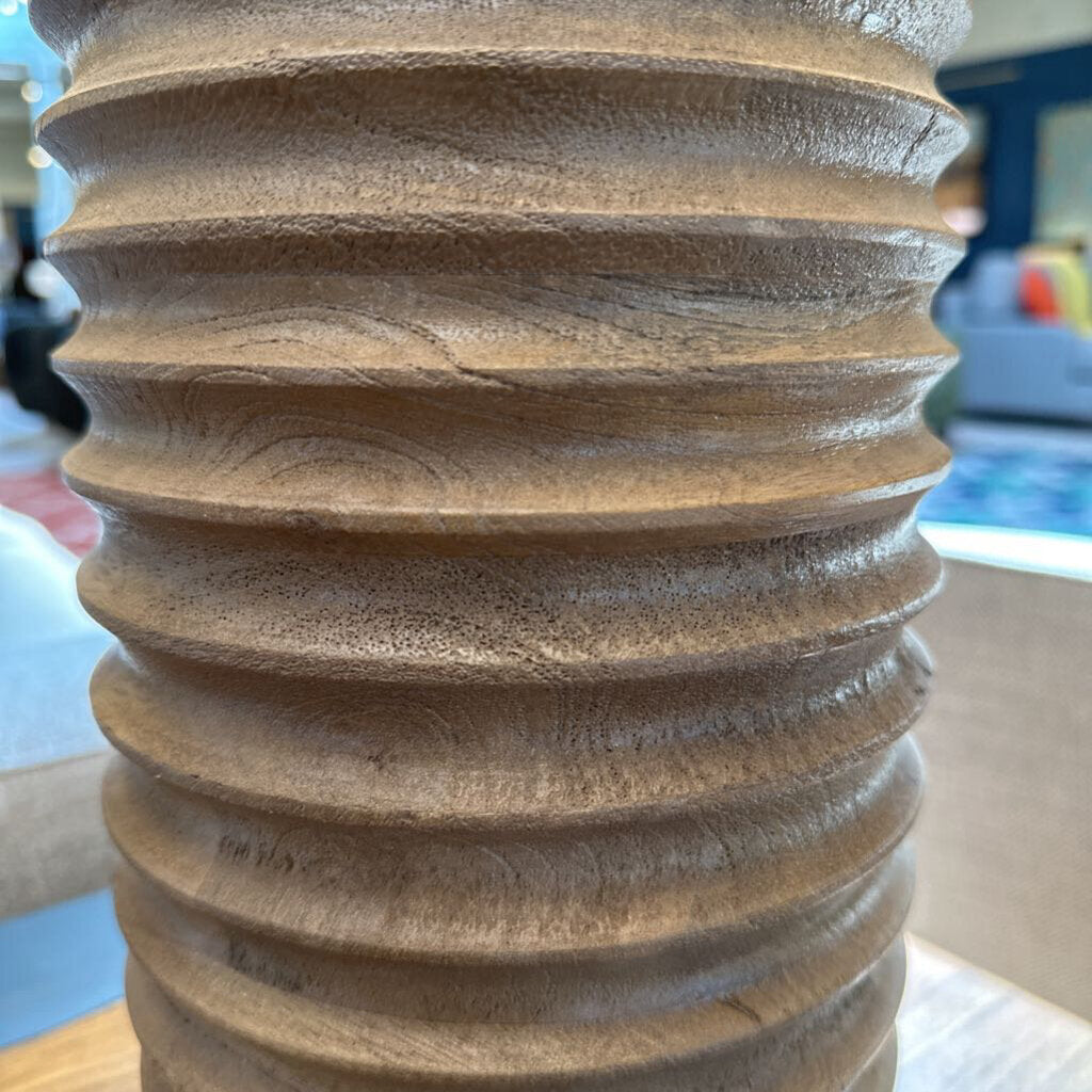Close-up of a textured brown vase with blurred background
