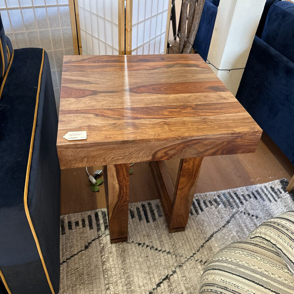 Wooden side table in a room with furniture and decor