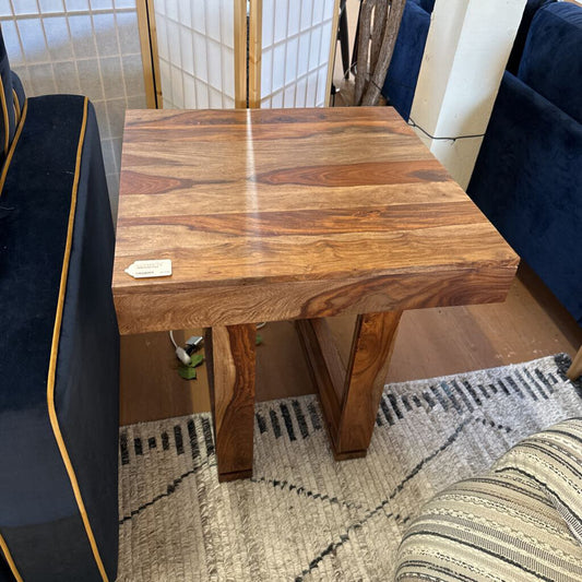 Wooden side table in a room with furniture and decor