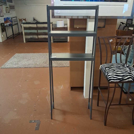 Tall metal shelving unit in a room with a chair and rug.