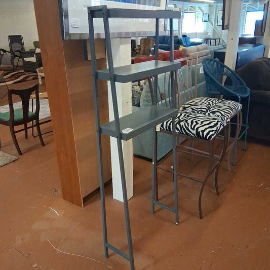 Metal ladder against a wall in a room with furniture and decor