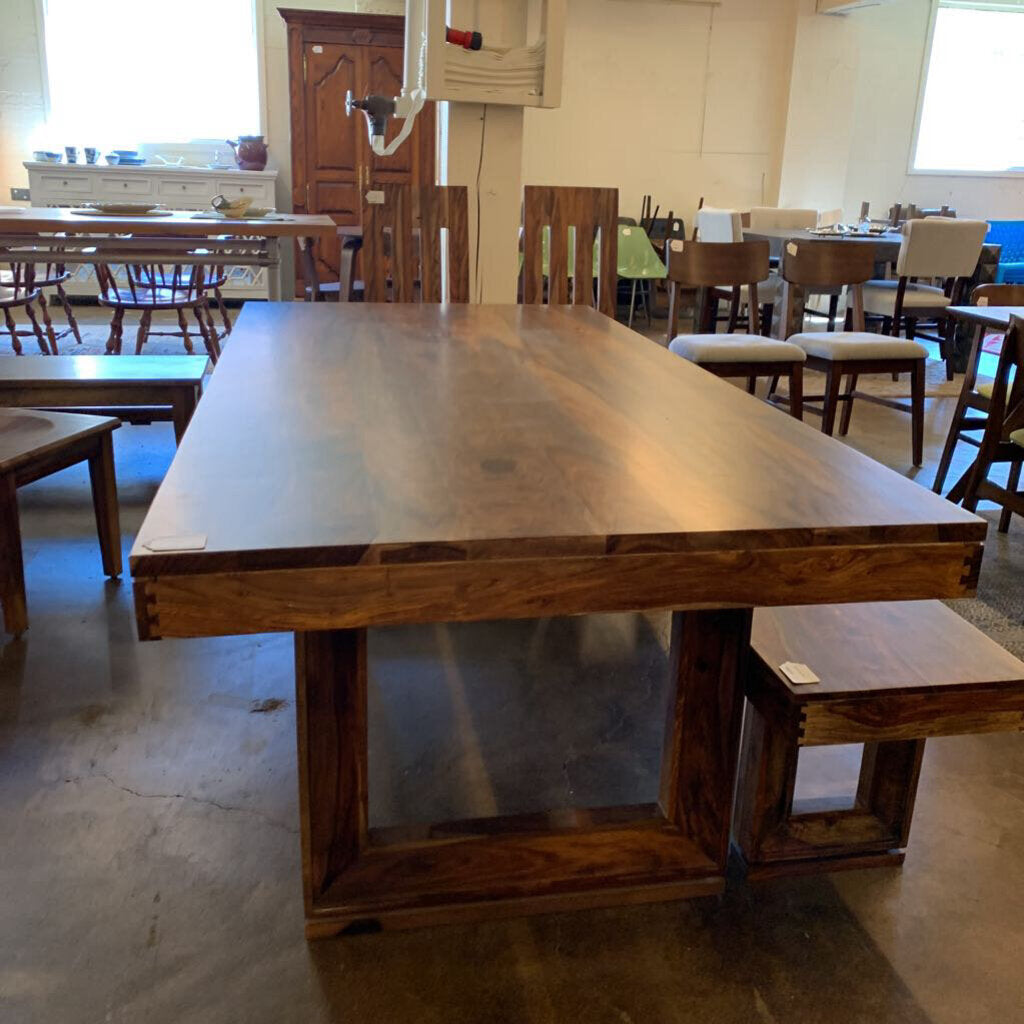 Wooden dining table with chairs in a room setting