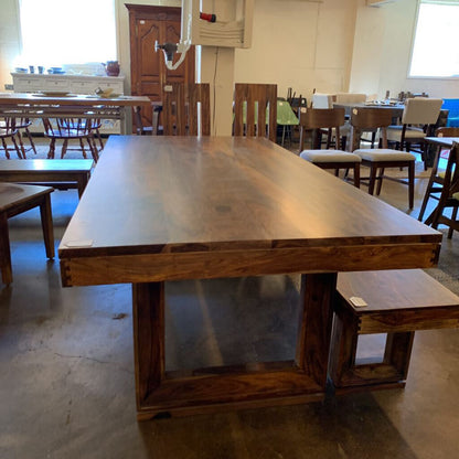 Wooden dining table with chairs in a room setting