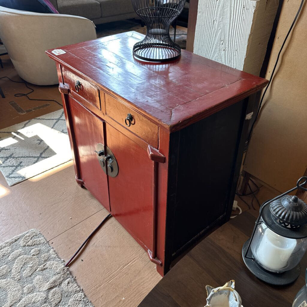 Wooden cabinet with a red finish in a room setting