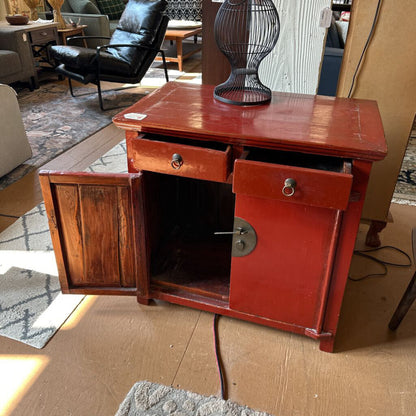 Wooden sideboard with open doors in a room setting