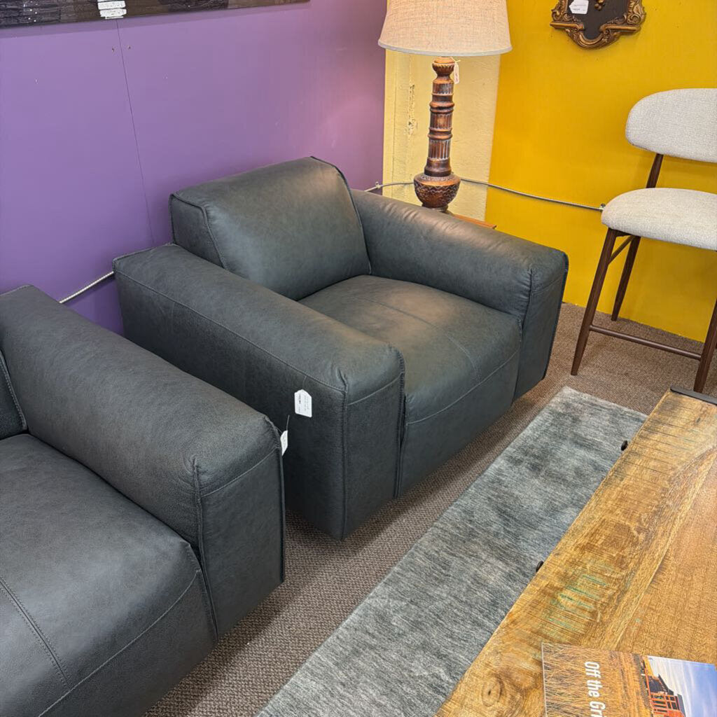 Gray sofa in a room with a purple wall and yellow accent.