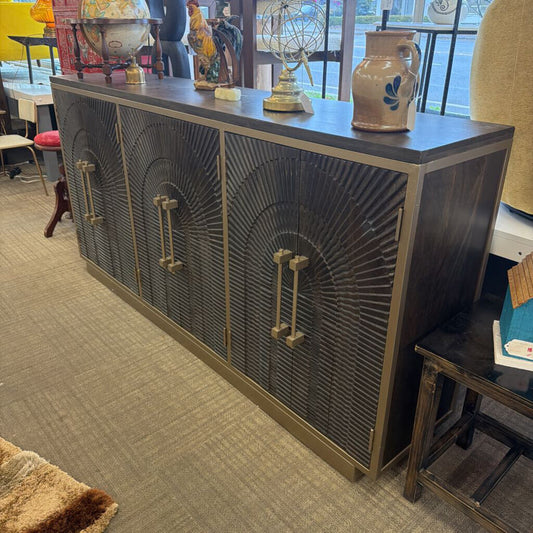 Decorative wooden cabinet with intricate design in a room setting