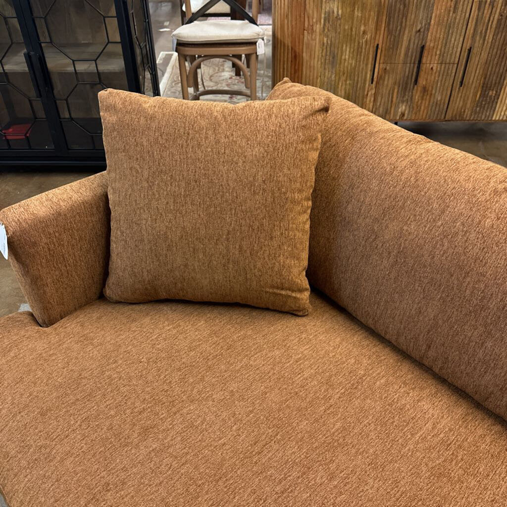 Brown sofa with a pillow in an indoor setting