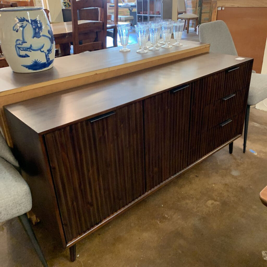 Wooden sideboard with glassware on a table in a room setting