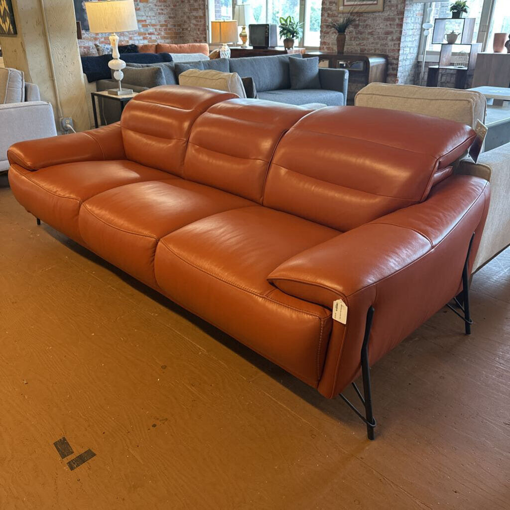 Brown leather sofa in a room with other furniture and decor.