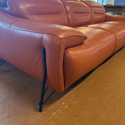 Brown leather sofa on a wooden floor