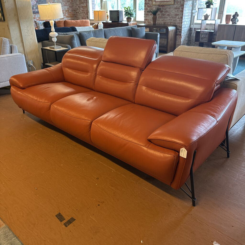 Brown leather sofa in a room with other furniture and decor.