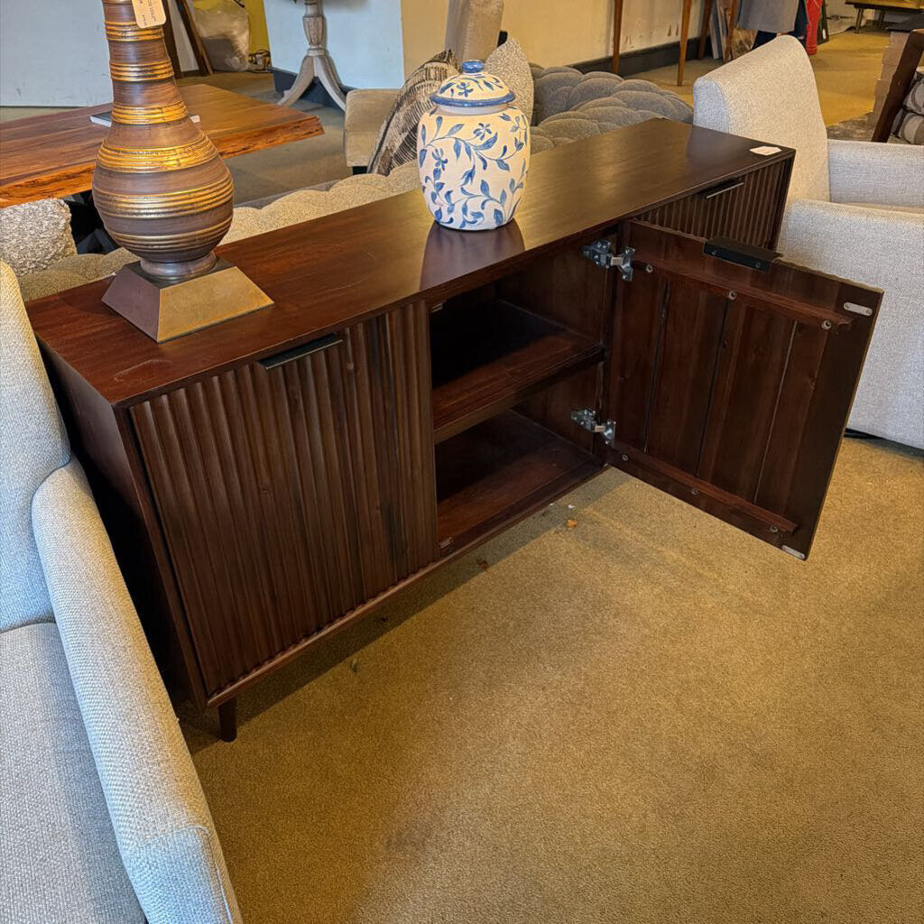 Wooden sideboard with open doors in a living room setting