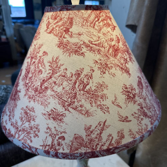 Lampshade with red floral pattern on a neutral background