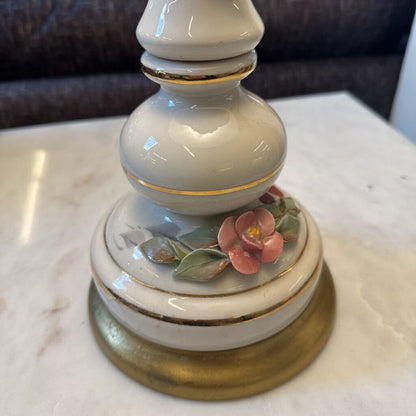 Decorative ceramic object with floral design on a marble surface