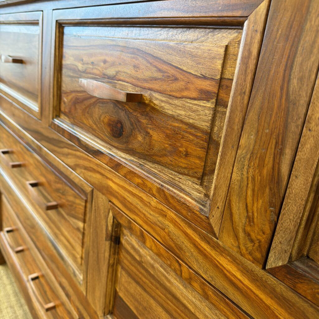 Close-up of a wooden cabinet with a focus on the grain and texture of the wood.
