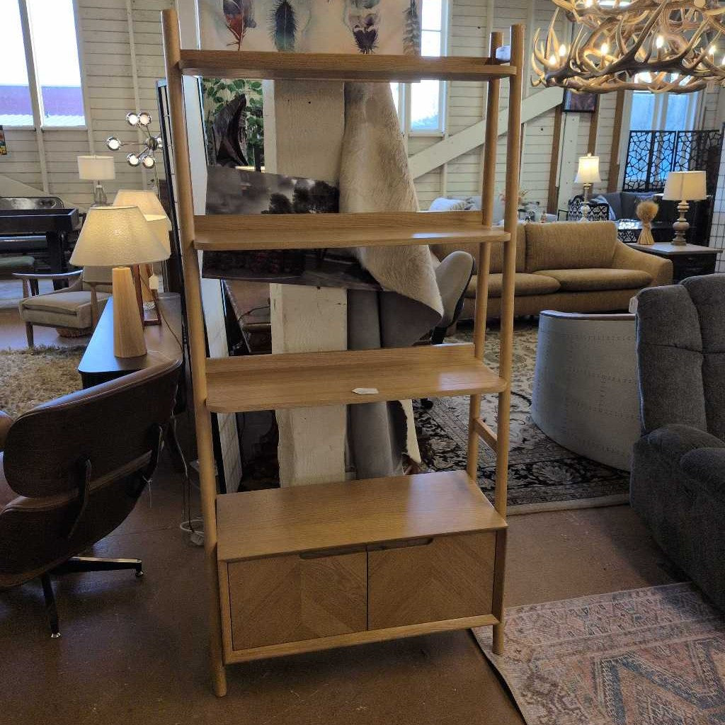 Wooden bookshelf in a living room setting with furniture and decor.