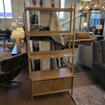 Wooden bookshelf in a living room setting with furniture and decor.