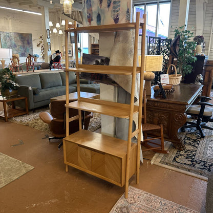 Wooden bookshelf in a room with furniture and decor