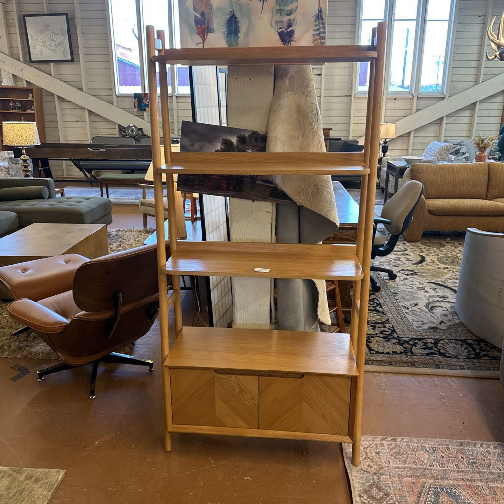 Wooden ladder shelf in a living room setting with furniture and decor.