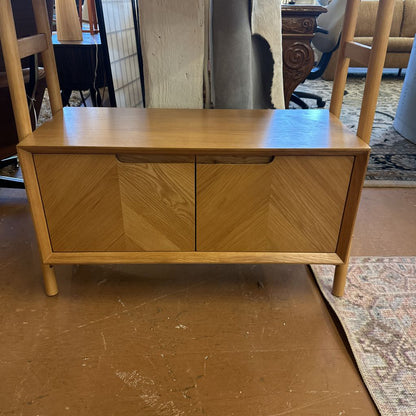 Wooden sideboard with two doors in a room setting