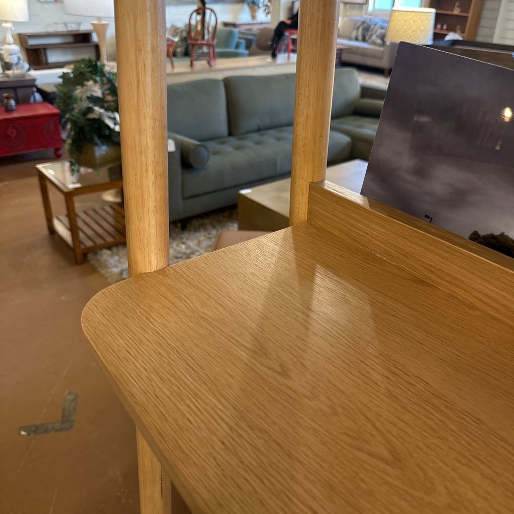 Wooden vanity table with mirror in a room with furniture and decor.