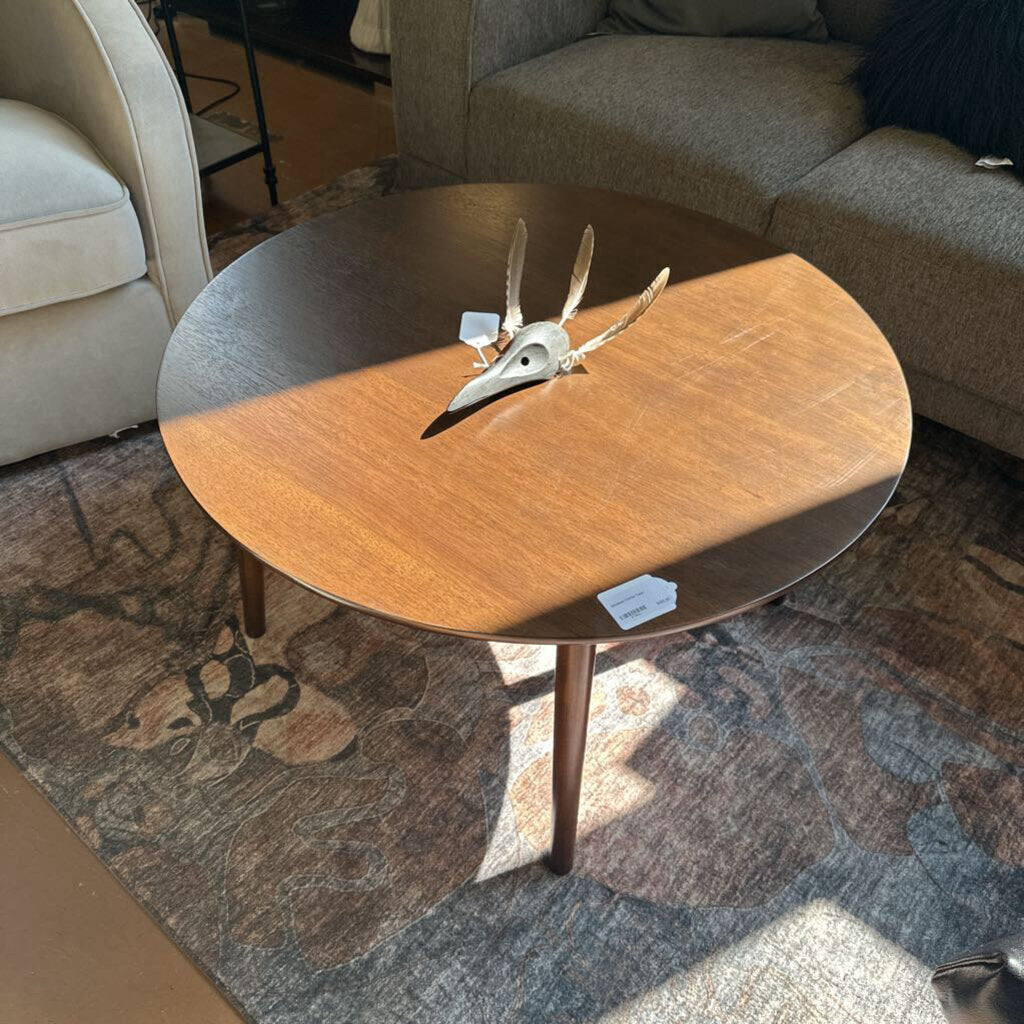 Wooden coffee table with decorative items in a living room setting