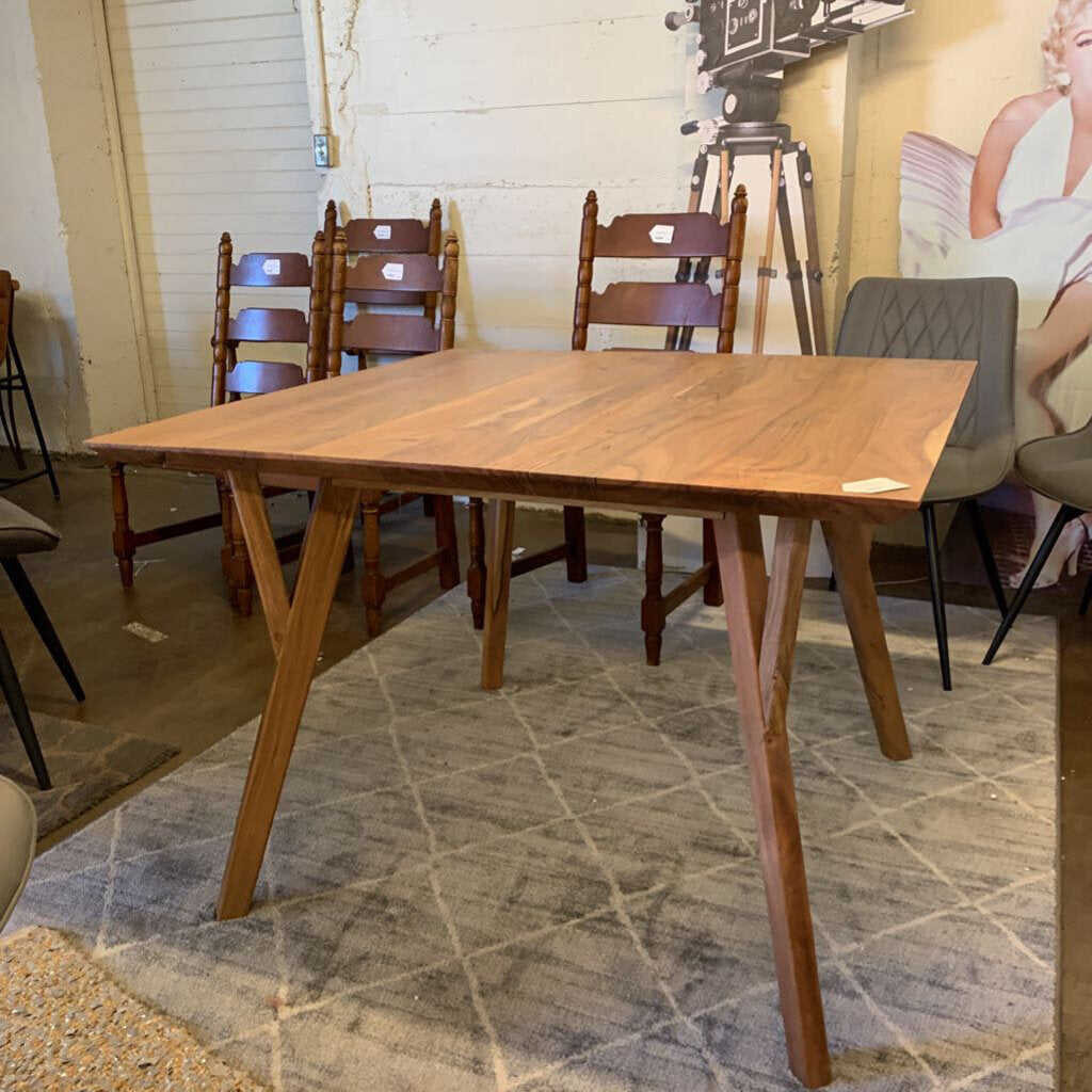 Wooden dining table with chairs in a room setting