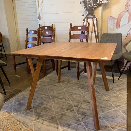 Wooden dining table with chairs in a room setting