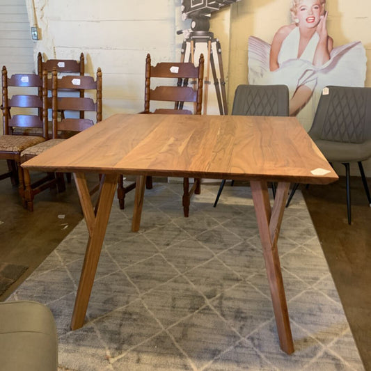 Wooden dining table with chairs in a room setting