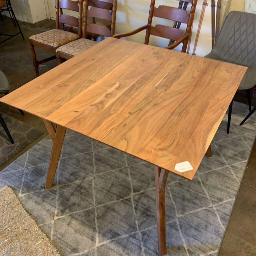 Wooden dining table with chairs in a room with tiled floor