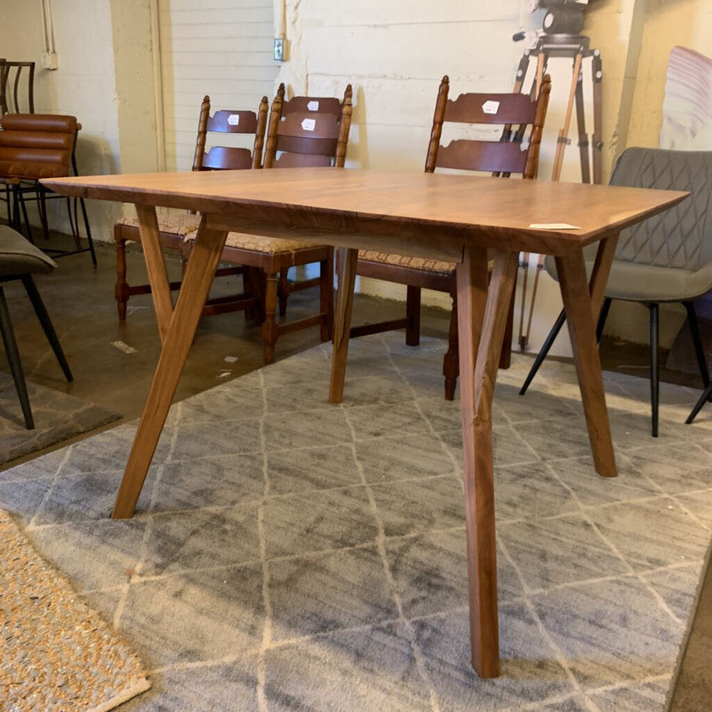 Wooden dining table with chairs in a room setting