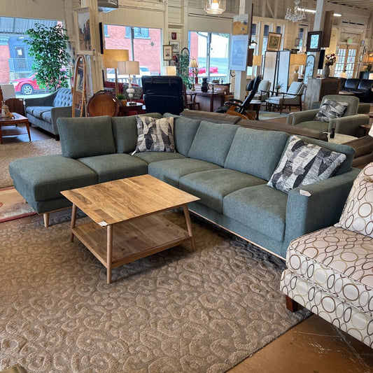Sectional sofa with patterned cushions in a showroom setting