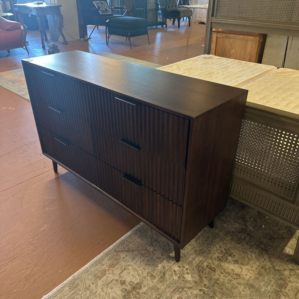 Dark wood dresser in a room with a rug and furniture