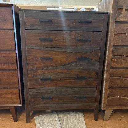 Wooden dresser with multiple drawers in a room setting