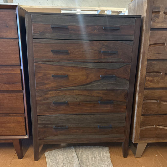 Wooden dresser with multiple drawers in a room setting
